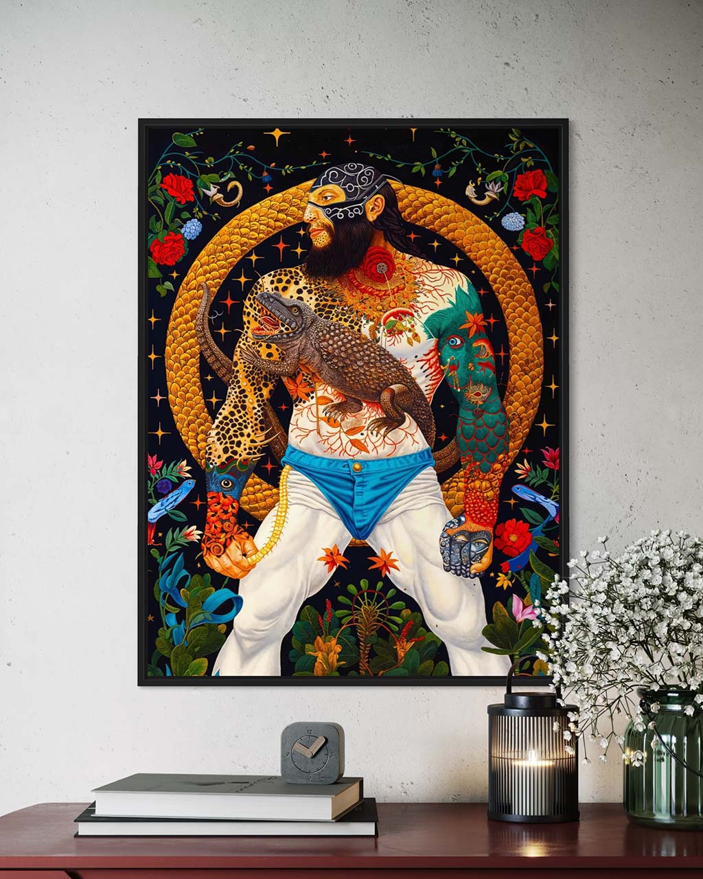 Art poster hanging on the wall. The poster features a muscular man with a lizard, surrounded by vibrant flora and a golden serpent.