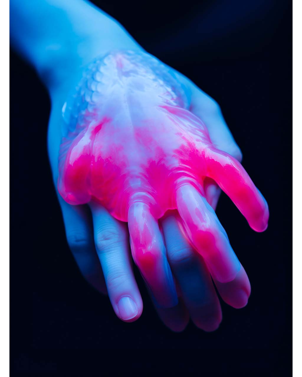 Poster art. Surrealist closeup image of a hand in pink and blue.