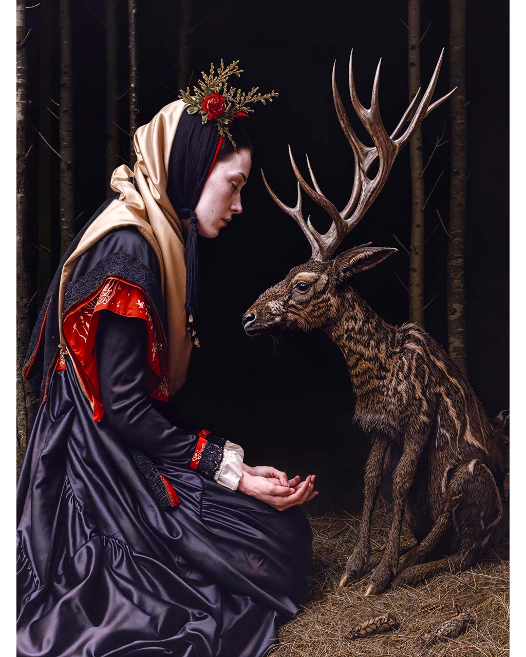 Woman feeding a deer in the dark forest