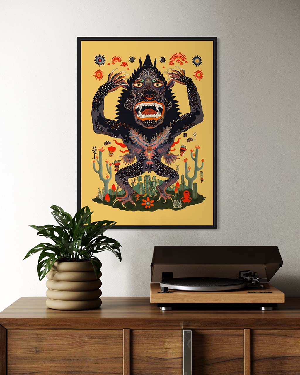 Framed art poster on the wall in a modern setting. Surreal poster features an illustration of a fierce monster with big teeth.